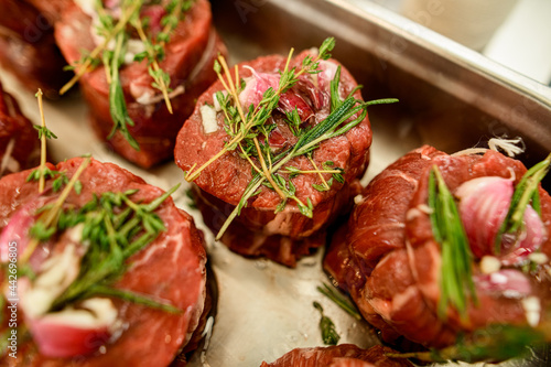 Close-up of raw meat steak with pepper and salt and sprigs of rosemary