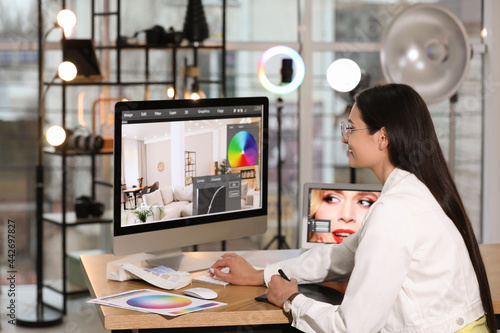 Professional retoucher working on computer in office © New Africa