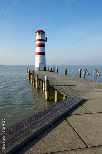 Lighthouse at Lake Neusiedl at beautiful sunny day and blue sky. Wonderful panorama at sea. Neusiedler See  Burgenland  Austria. Beautiful panorama at Lake with lighthouse.