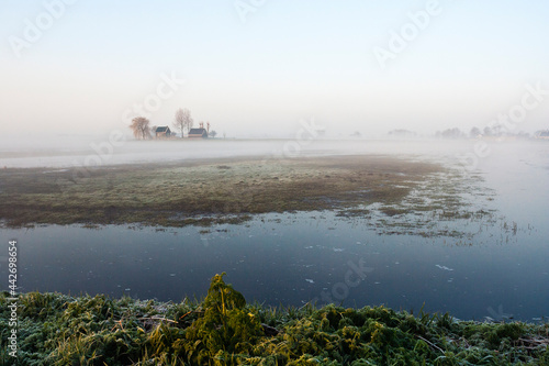 House in misty meadow photo