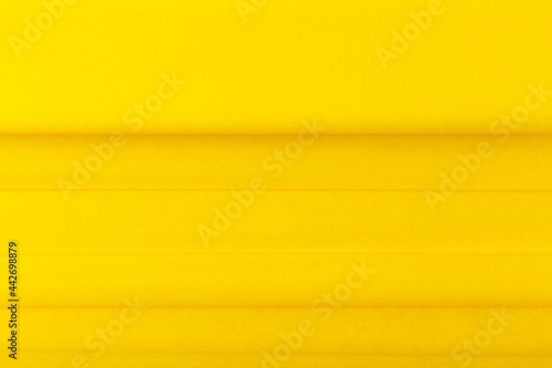 Bright yellow abstract background with horizontal lines and copy space. Trendy textured colored background. Concept of modern template for website or advertising banner 