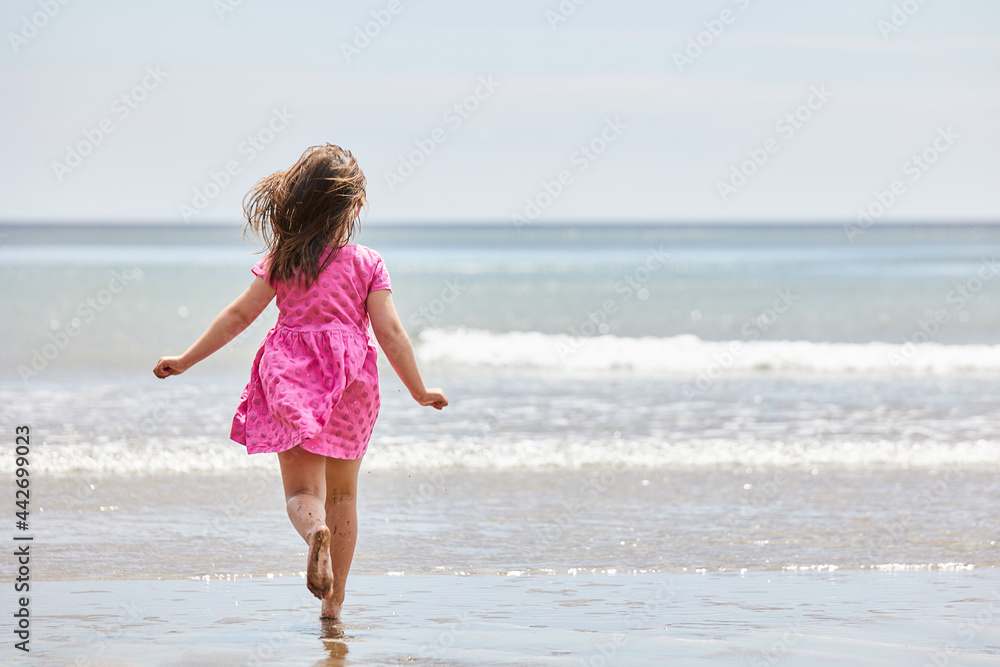 Caucasian girl running to the sea with great copy space for advertising Caucasian girl running to the sea with great copy space for advertising
