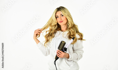 Online shop. Useful Curling Iron Tricks Everyone Should Know. Create hairstyle with curling iron. Woman with long curly hair use curling iron. Hairdresser tips. Girl adorable blonde. Buy tools
