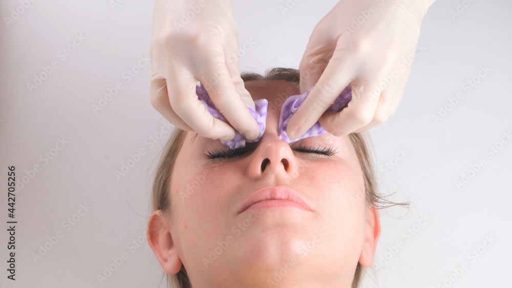 Beautiful girl has a facial massage in a beauty clinic. Facial skin care concept .