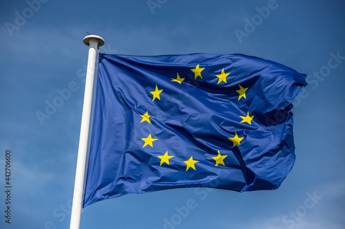 european flag blowing in blue sky