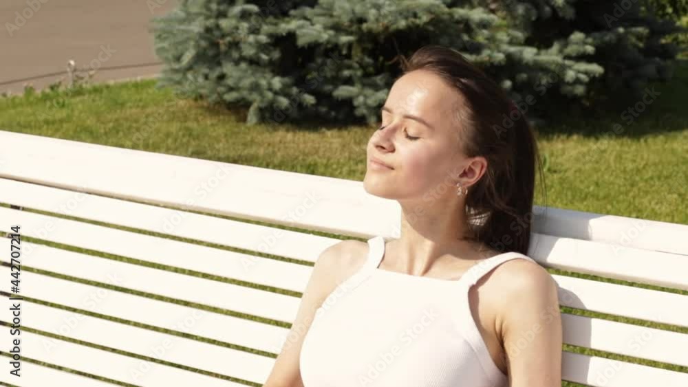 teen sunbathing, girl in summer, in hot weather on a sunny day on a bench in the park teen sunbathing, girl in summer, in hot weather on a sunny day on a bench in the park