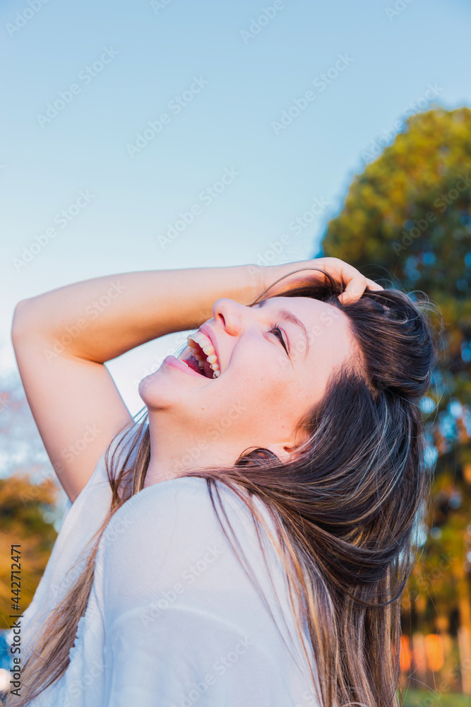 Fototapeta premium Portrait of young woman smiling at outdoor