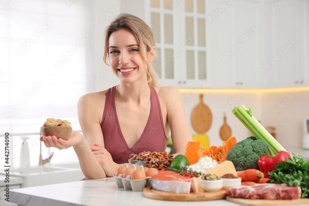 Woman with healthy food in kitchen. Keto diet