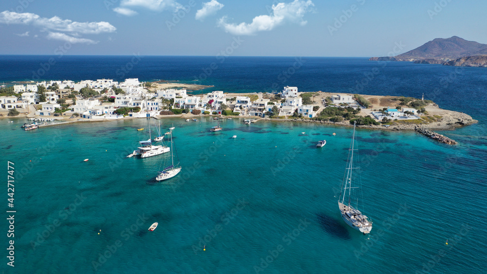 Obraz premium Aerial drone photo of picturesque fishing village of Polonia or Pollonia with traditional fishing boats anchored next to island of Kimolos, Milos island, Cyclades, Greece