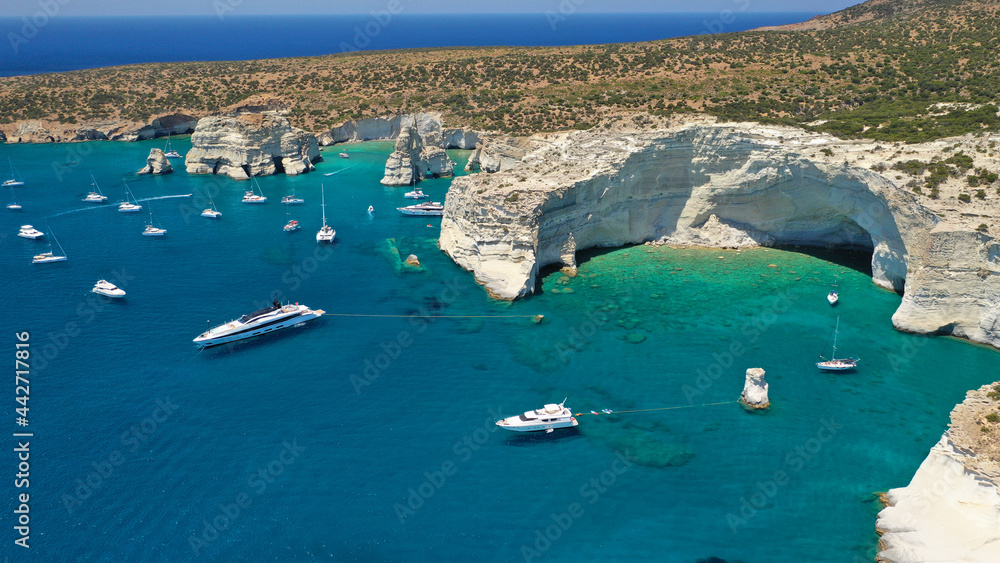 Arial drone photo of Kleftiko a beautiful scenic white volcanic rock formation bay visited by sail boats and yachts with turquoise crystal clear sea and caves, Sea Meteora of Greece, Milos island