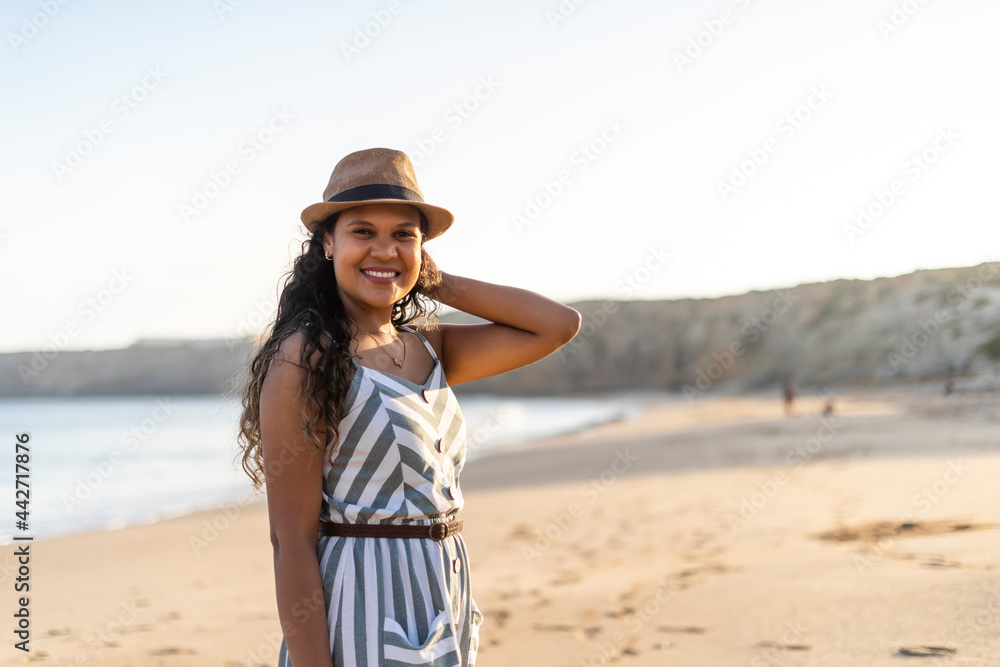 Portrait of a beautiful young woman on the beach by sunset Portrait of a beautiful young woman on the beach by sunset