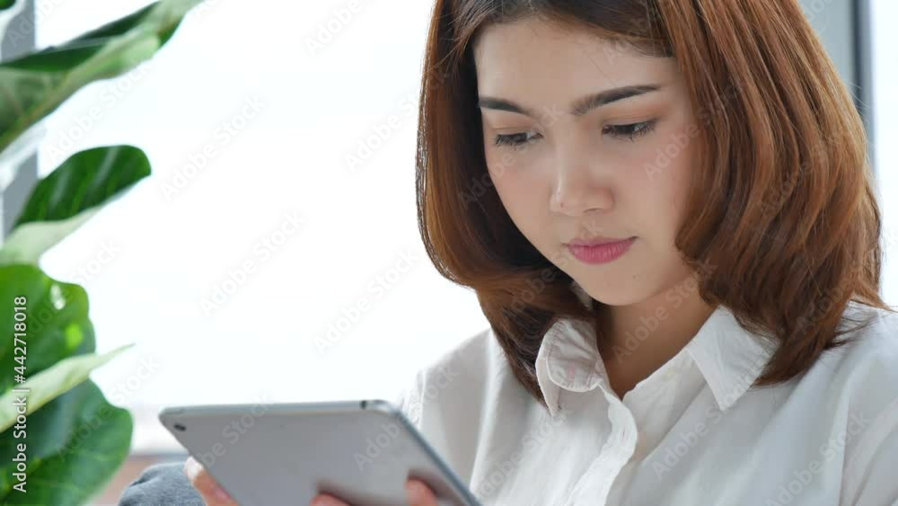 Asian woman using digital tablet shopping online, call, texting message internet technology lifestyle with smiling face. Asian woman touch smart tablet focus on hands using mobile app home office. Asian woman using digital tablet shopping online, call, texting message internet technology lifestyle with smiling face. Asian woman touch smart tablet focus on hands using mobile app home office.