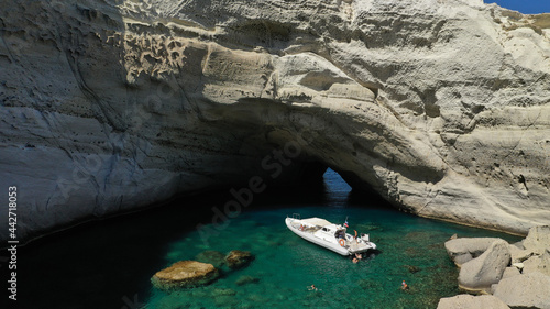 Aerial drone photo of beautiful volcanic open cave of Sykia a geological phenomenon - leaving an opening for small boat to enter in South West of Milos island, Cyclades, Greece