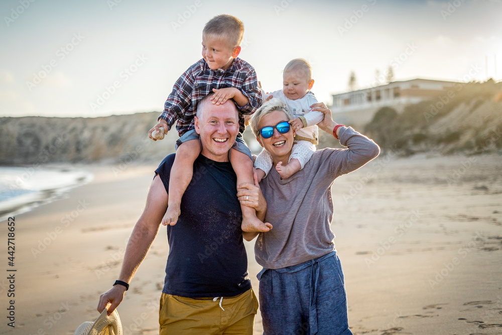 The family with two small boys enjoying time on the beach in Portugal