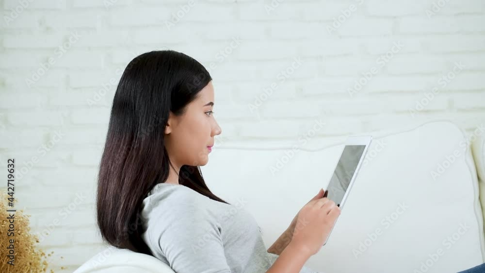 Asian woman using digital tablet shopping online, call, texting message internet technology lifestyle with smiling face. Asian woman touch smart tablet focus on hands using mobile app home office. Asian woman using digital tablet shopping online, call, texting message internet technology lifestyle with smiling face. Asian woman touch smart tablet focus on hands using mobile app home office.