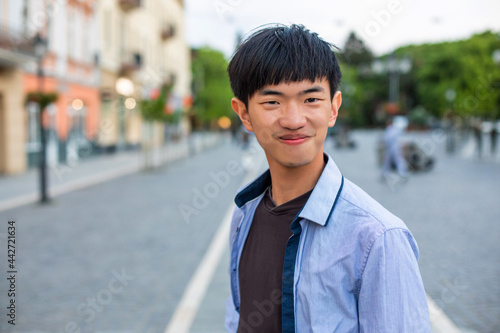 Attractive young student on old european city background