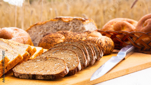 lot of different flavored bread, wheat, rye, on the table in the field outside