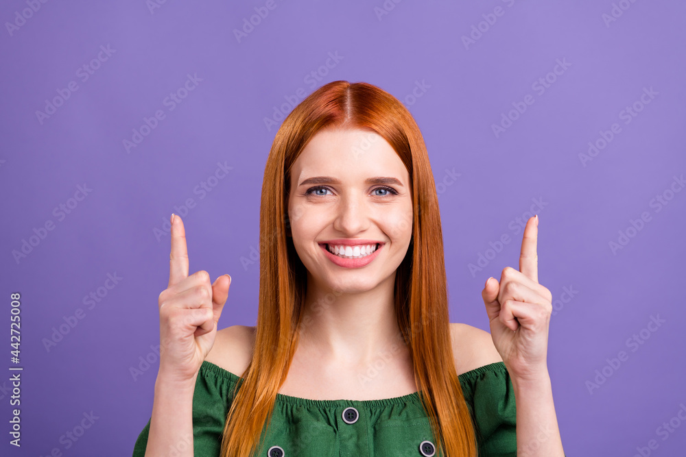 Photo of shiny sweet young lady wear green blouse pointing up empty space smiling isolated purple color background Photo of shiny sweet young lady wear green blouse pointing up empty space smiling isolated purple color background