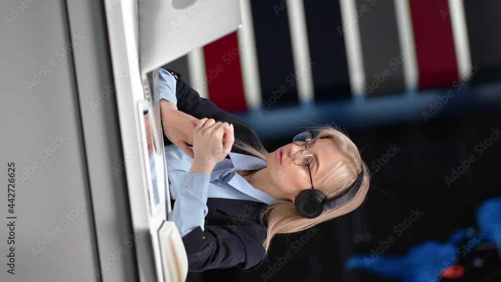 VERTICAL VIDEO POV business woman in headset talking online video call at infographics workplace VERTICAL VIDEO POV business woman in headset talking online video call at infographics workplace