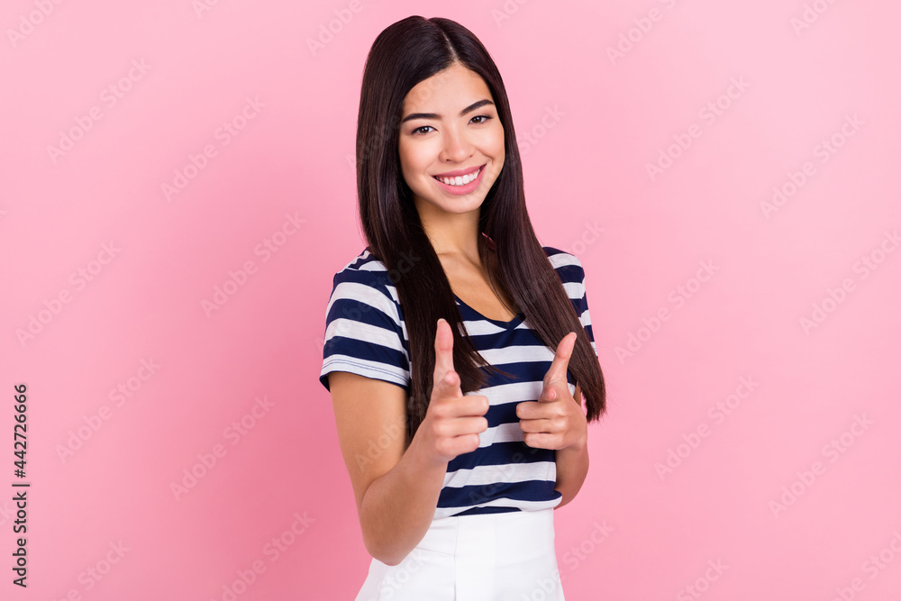 Photo of cool young millennial lady point camera wear striped t-shirt isolated on pastel pink color background Photo of cool young millennial lady point camera wear striped t-shirt isolated on pastel pink color background