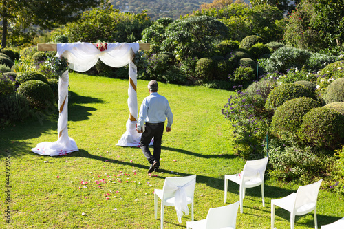 Senior caucasian male wedding officiant preparing before wedding ceremony