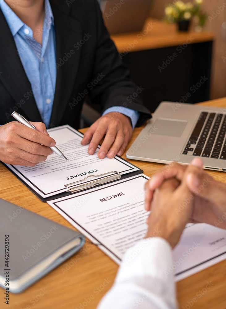 Human resources manager conducting job interview with applicant in the office, Candidate with resume at the job interview with human resource, Recruitment Human resources manager conducting job interview with applicant in the office, Candidate with resume at the job interview with human resource, Recruitment