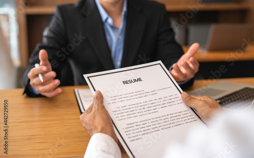 Human resources manager conducting job interview with applicant in the office, Candidate with resume at the job interview with human resource, Recruitment