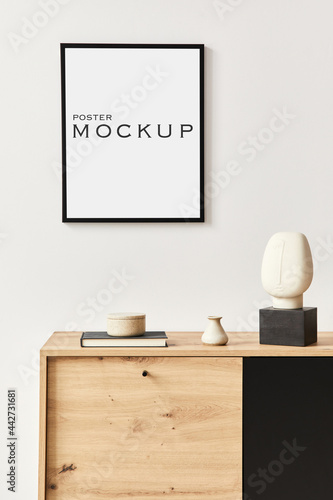 Stylish interior of living room with mock up poster frame, wooden commode, book, ceramic vessel and elegant personal accessories. Minimalist concept of home decor. Template. © FollowTheFlow