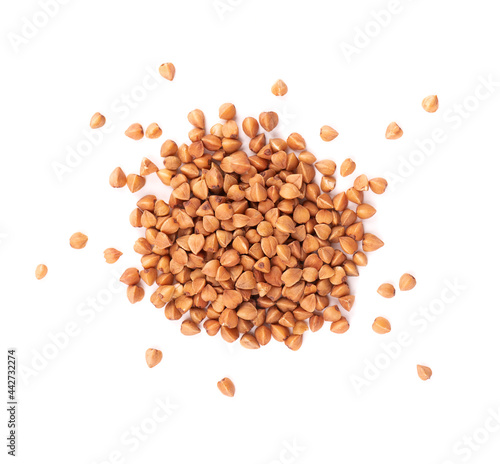Roasted buckwheat grains, isolated on white background. Dry brown buckwheat groats. Top view. photo