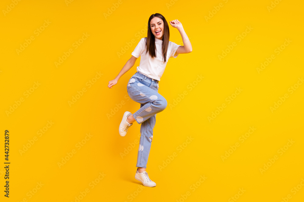 Full length photo of young excited girl happy positive smile have fun dance isolated over yellow color background