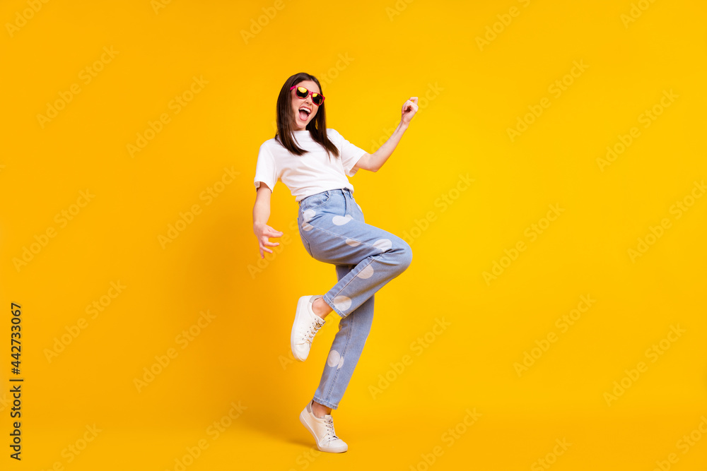 Full body profile side photo of young excited girl happy positive smile play guitar isolated over yellow color background