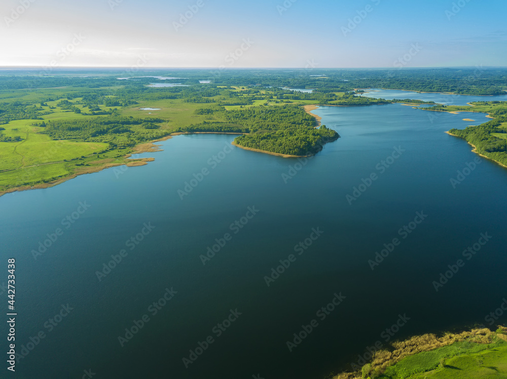 Beautiful aerial landscape on the lake with a drone. Many lake islands covered with forests, fields on a sunny day Beautiful aerial landscape on the lake with a drone. Many lake islands covered with forests, fields on a sunny day