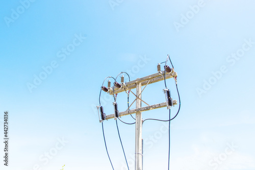 oblique photo concrete pole electric with power cable on pole Blue sky bright on background © Thepporn