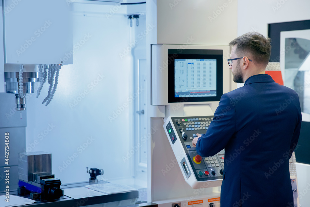 Maintenance engineer control automatic CNC machine in smart factory for metal. Concept industry factory Maintenance engineer control automatic CNC machine in smart factory for metal. Concept industry factory