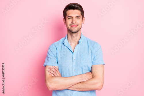 Photo of self-assured charming guy folded arms look camera wear blue shirt isolated on pink color background