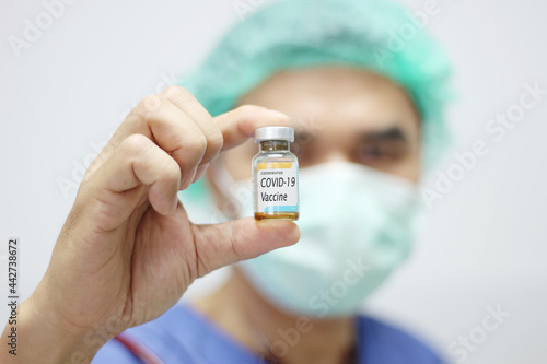 doctor holding covid - 19 coronavirus vaccine