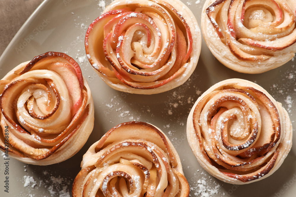 Freshly baked apple roses on plate. top view. Beautiful dessert Freshly baked apple roses on plate. top view. Beautiful dessert