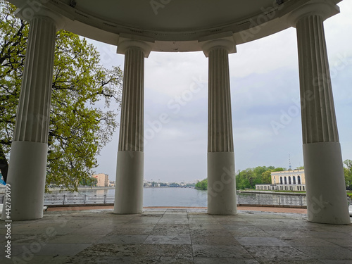 View from the pavilion "Under the flag" on the columns and the river in the park on the Elagin Island of St. Petersburg.