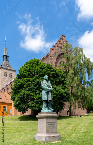 statue of Hans Christian Andersen in the park of Saint Canute Cathedral in downtown Odense