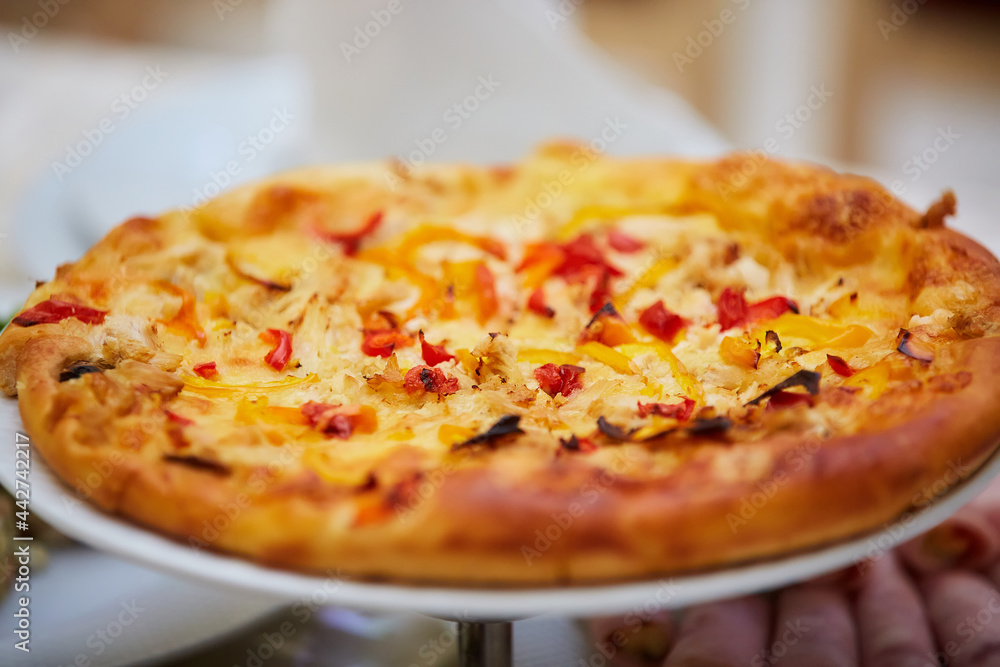 A boring fast food dish pizza. Italian cuisine. Cooking in a restaurant or with your own hands
