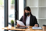 Business woman wear mask while using calculator with computer laptop, Business accounting, budget and loan paper in office