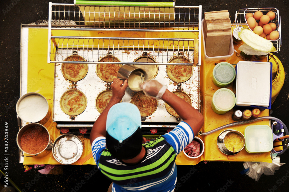 Filipino chef vendor cooking local street food philippine style at