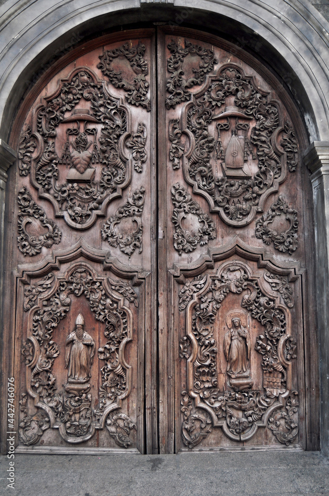 Antique carving wooden door window of Convento de san agustin church or Archdiocesan Shrine of Nuestra for Filipino people foreign traveler travel visit in intramuros at Maynila in Manila, Philippines