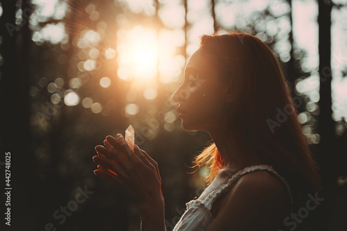 Red-haired beautiful woman holding magic crystal. Meditation Spiritual