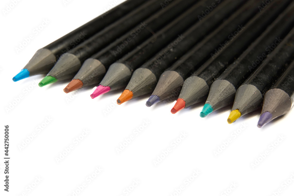 Colored pencils lying diagonally on white background. Colored pencils lying diagonally on white background.