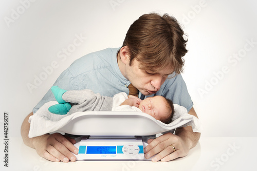 Father take care of his newborn baby boy photo