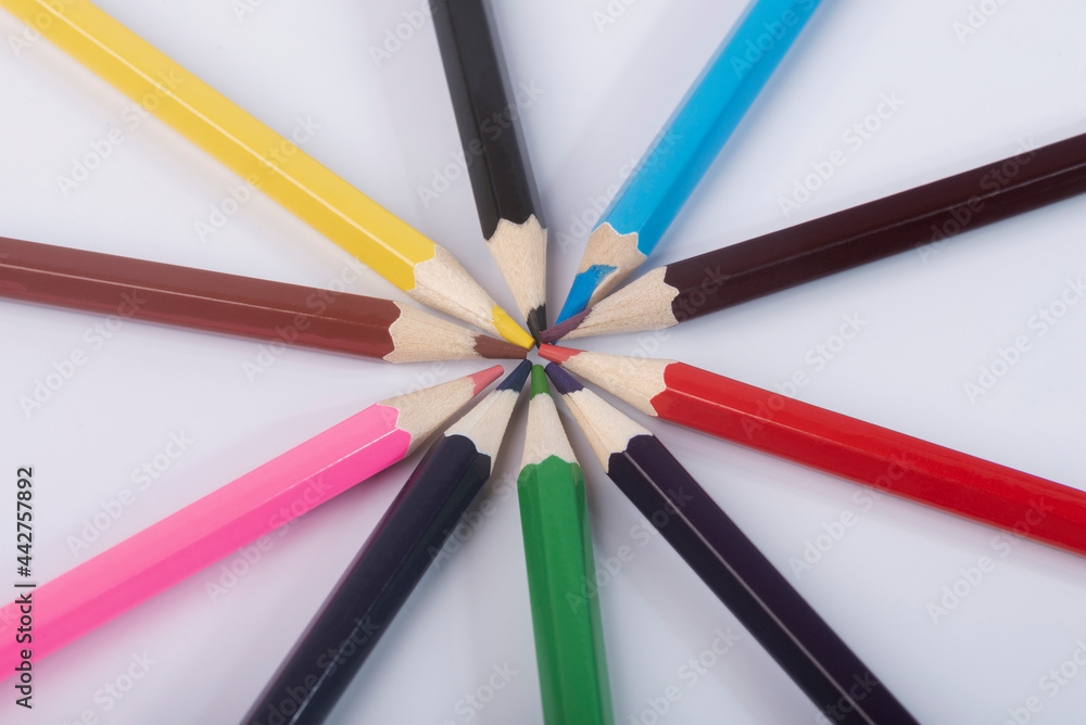 Colored pencils on an isolated white background close-up. Colored pencils for drawing a colored rainbow. Colored pencils on an isolated white background close-up. Colored pencils for drawing a colored rainbow.