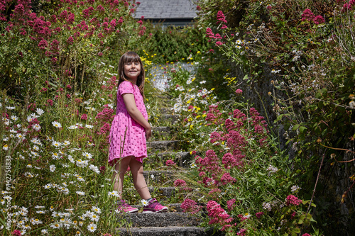 Caucasian girl surrounded by flowers, summer or spring image