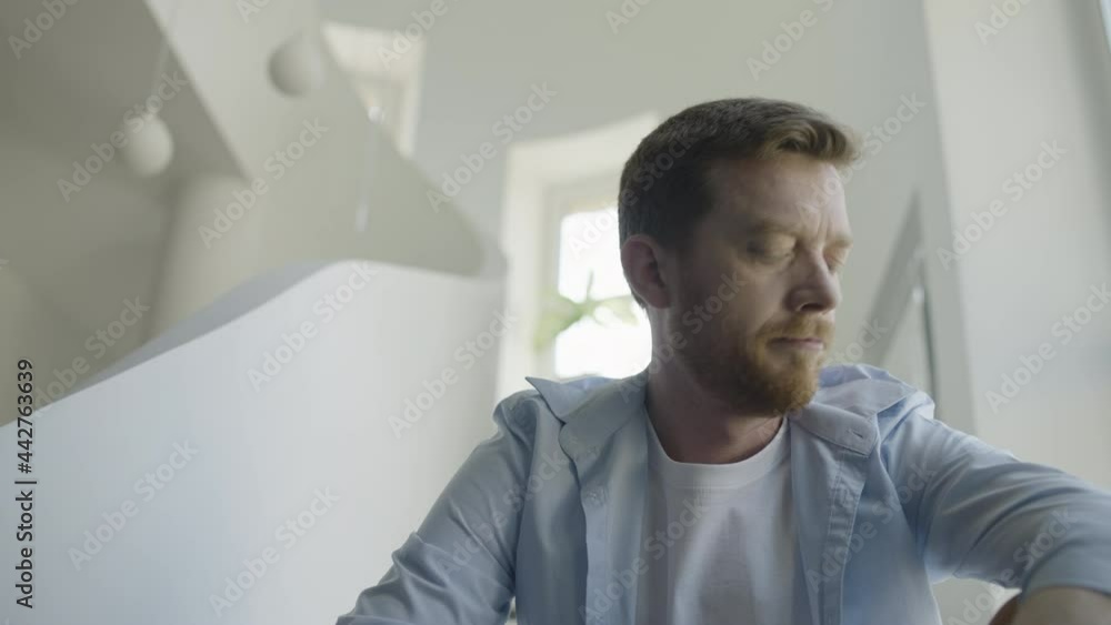 Sad middle-aged man sitting on office stairs, company bankruptcy, got fired Sad middle-aged man sitting on office stairs, company bankruptcy, got fired