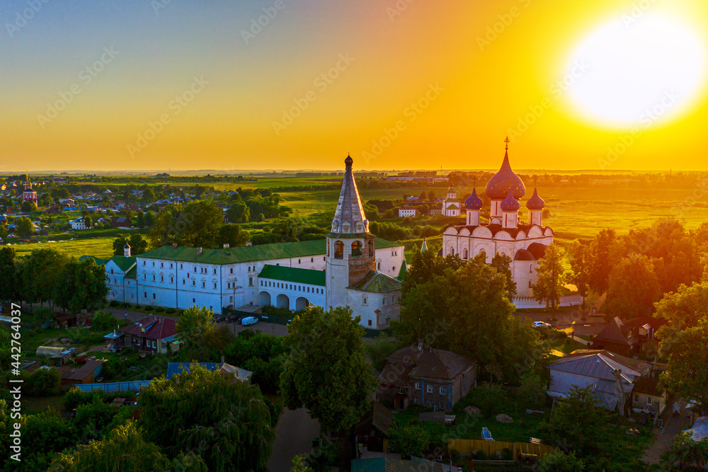 Aerial drone view of Suzdal Kremlin and cathedral of Nativity at the Kamenka river, Russia. Summer sunny day sunset
